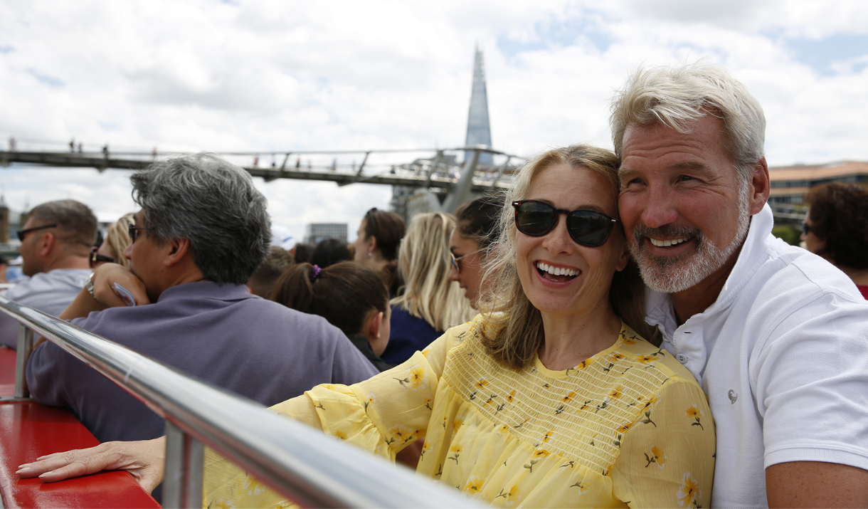 A couple enjoy the views from the top deck of City Cruises
